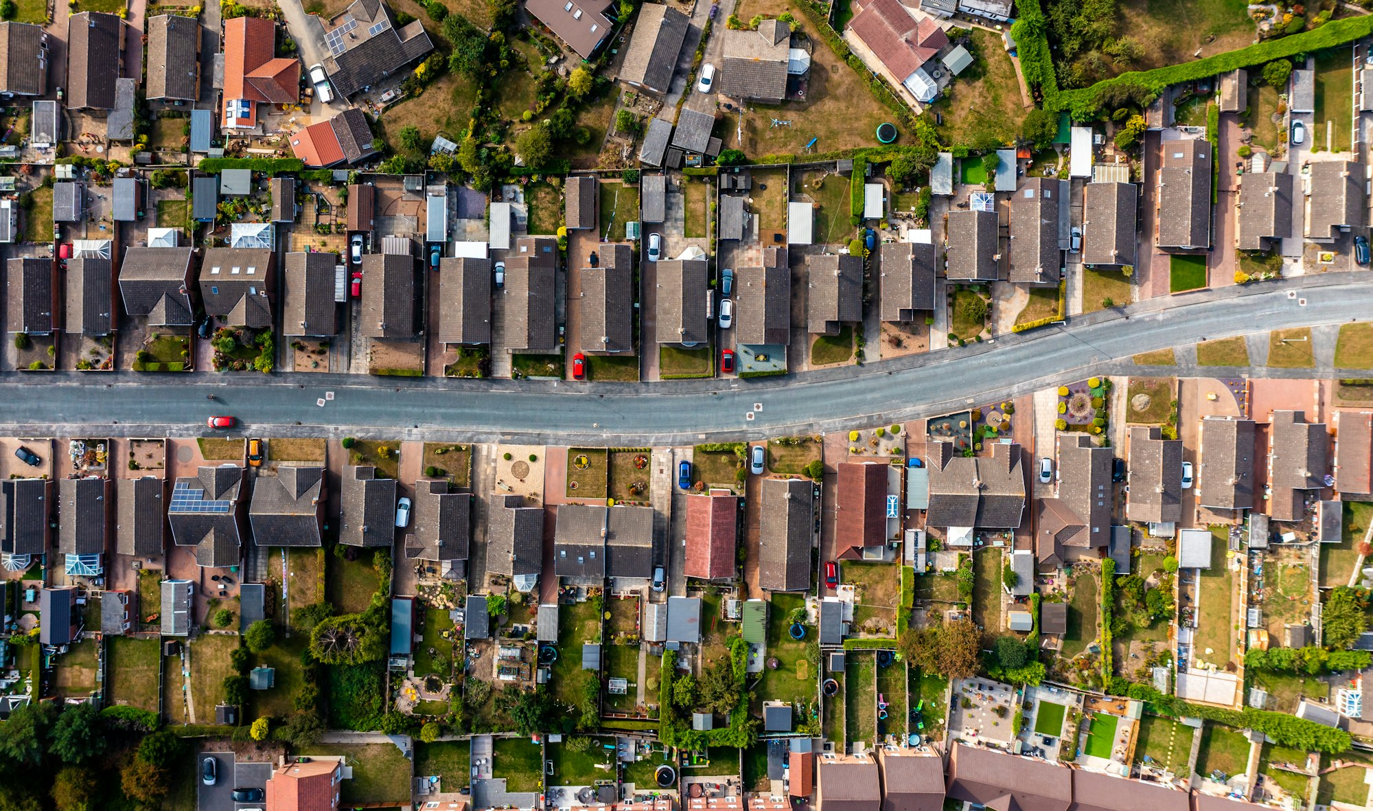 Aerial view directly above a road through a suburban housing estate